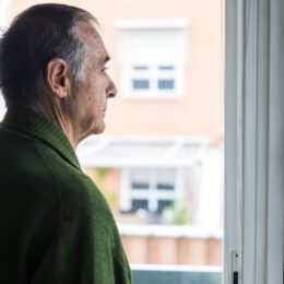 Man looking out of a window.