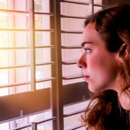 Woman looking out at window.