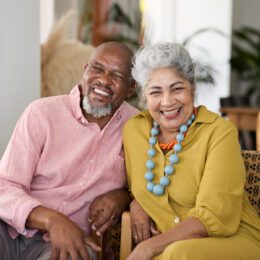A couple on the couch smiling